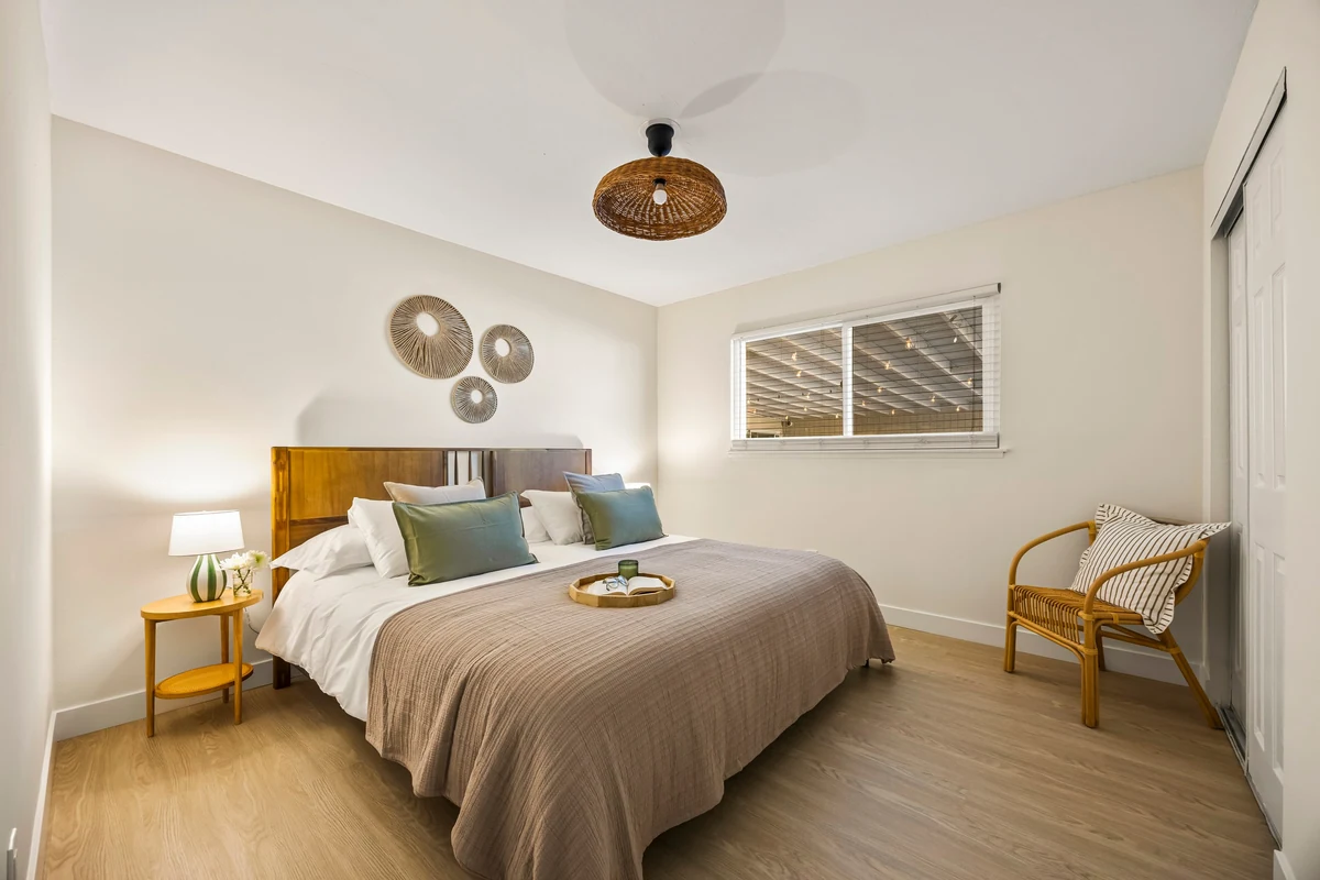 Bedroom with woven wall decorations and a wooden accent chair